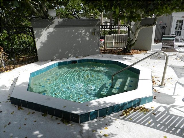 view of swimming pool featuring a community hot tub