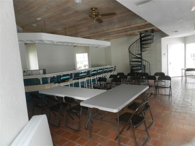 dining space with ceiling fan and wood ceiling