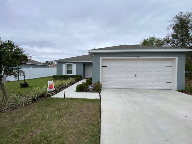 single story home with a garage and a front yard