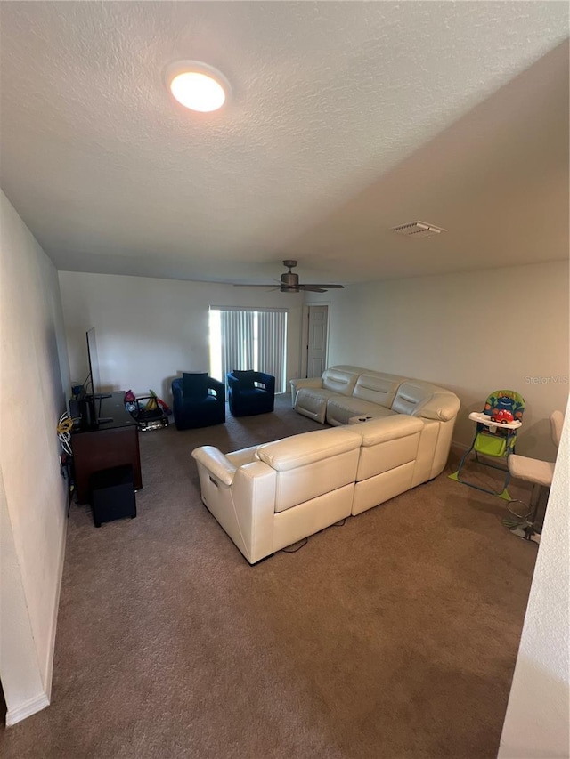 carpeted living room with a textured ceiling and ceiling fan