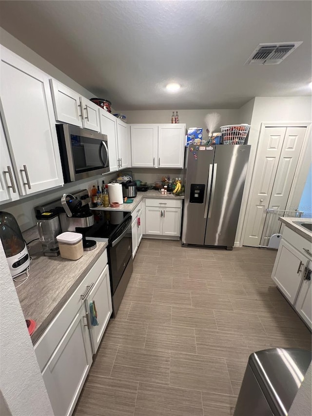 kitchen with white cabinets and stainless steel appliances