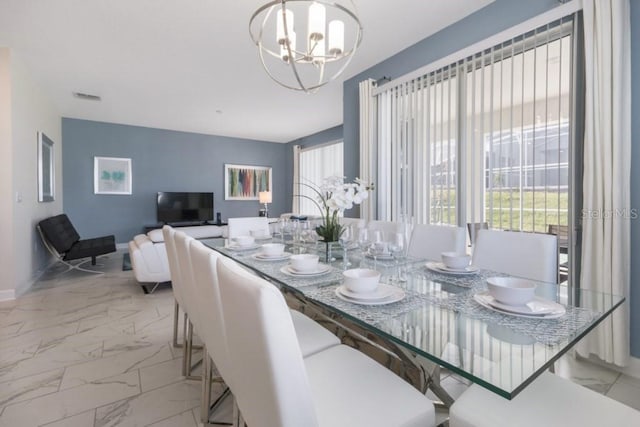 dining space featuring a healthy amount of sunlight and a chandelier