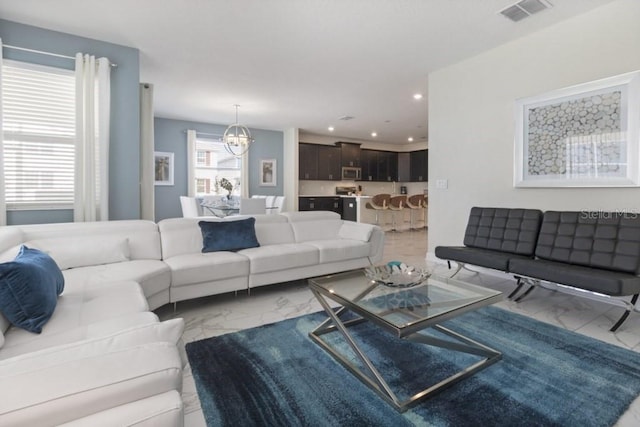 living room with an inviting chandelier