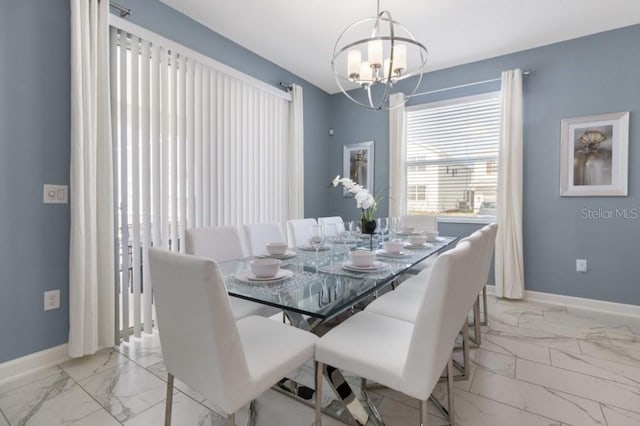 dining area with an inviting chandelier