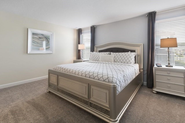 bedroom featuring dark colored carpet