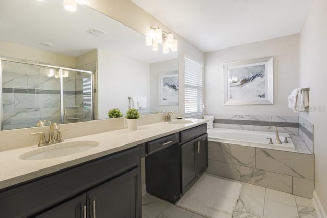 bathroom with vanity and shower with separate bathtub