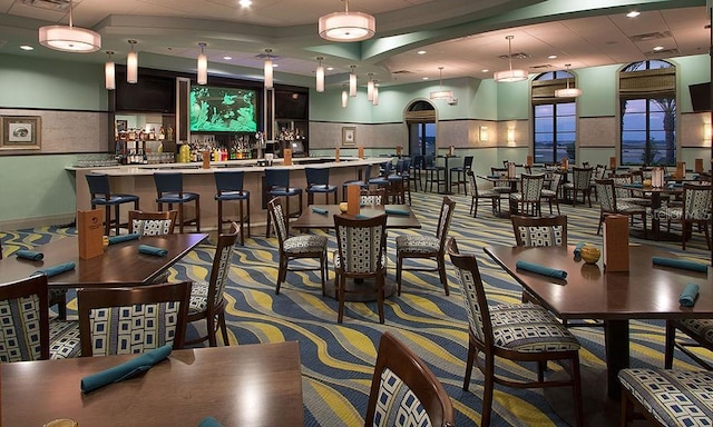 bar with hanging light fixtures