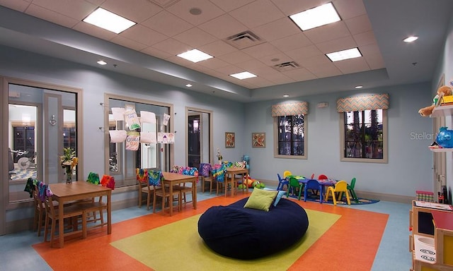 recreation room featuring a drop ceiling