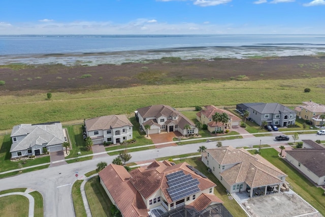 birds eye view of property with a water view and a view of the beach