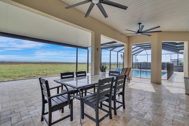 view of patio featuring a lanai and ceiling fan