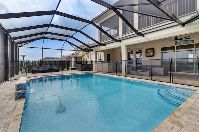 view of swimming pool featuring glass enclosure, an outdoor living space, ceiling fan, and a patio