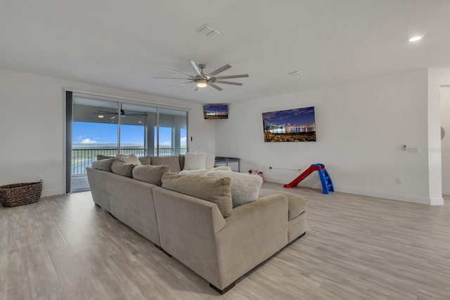 living room with ceiling fan and light wood-type flooring