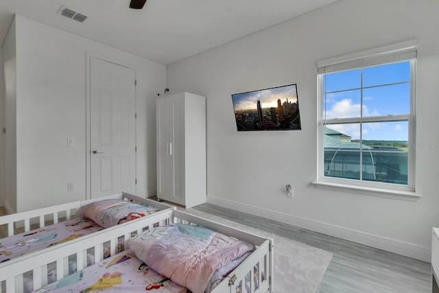 bedroom featuring ceiling fan and light hardwood / wood-style flooring