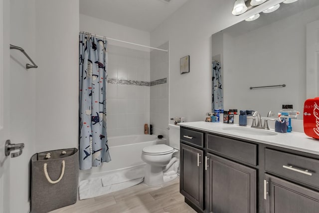 full bathroom featuring shower / bath combination with curtain, vanity, hardwood / wood-style flooring, and toilet