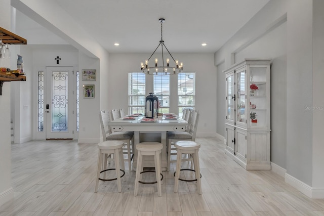 820 Windlass Ct, Kissimmee, FL 34746 - dining space featuring a notable chandelier, baseboards, and light wood-style floors
