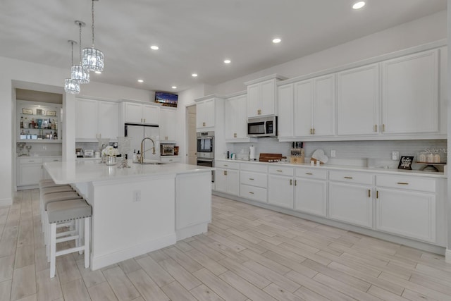 820 Windlass Ct, Kissimmee, FL 34746 - kitchen with white cabinets, tasteful backsplash, stainless steel appliances, and a sink