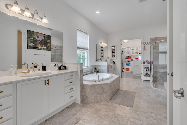 820 Windlass Ct, Kissimmee, FL 34746 - bathroom with vanity, a shower stall, a bath, and a walk in closet