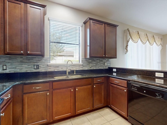 kitchen with sink, dishwasher, tasteful backsplash, light tile patterned flooring, and dark stone counters