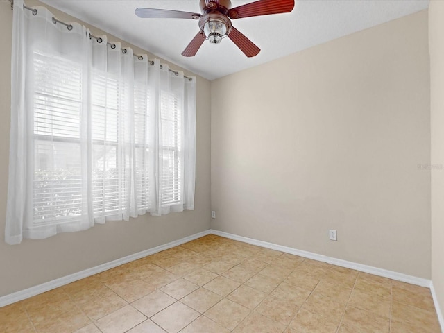 tiled empty room with ceiling fan