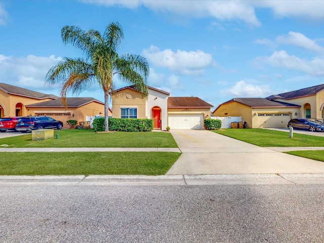 mediterranean / spanish house with a garage and a front lawn