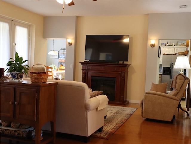 living room featuring ceiling fan and wood-type flooring