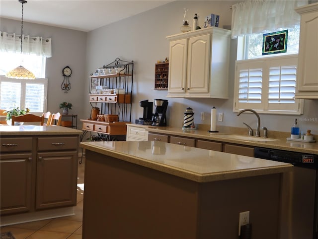 kitchen featuring dishwasher, pendant lighting, a center island, sink, and light tile patterned floors