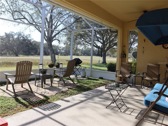 view of patio featuring a lanai