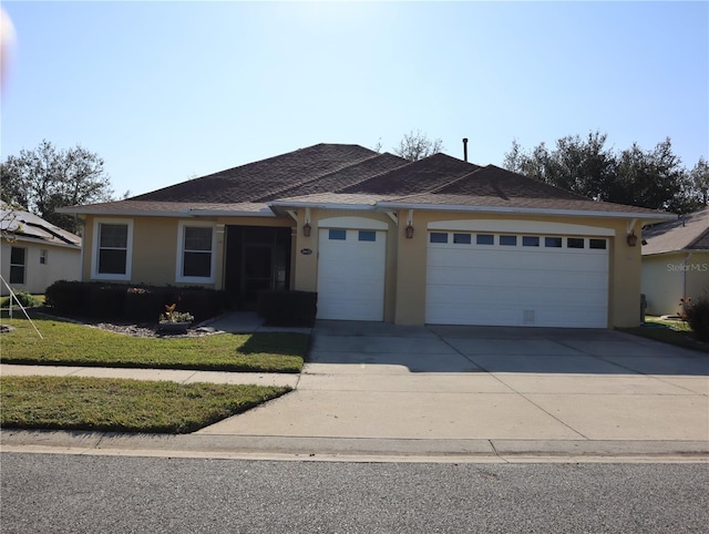 ranch-style home featuring a garage and a front yard