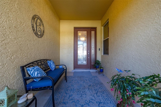 property entrance with stucco siding