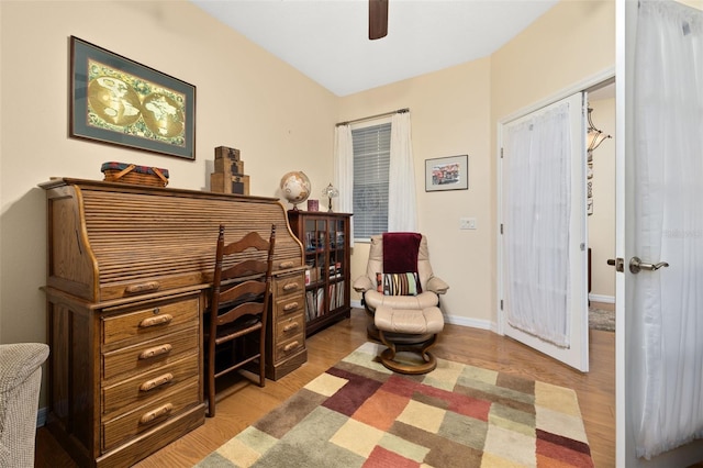 office with wood finished floors, a ceiling fan, and baseboards