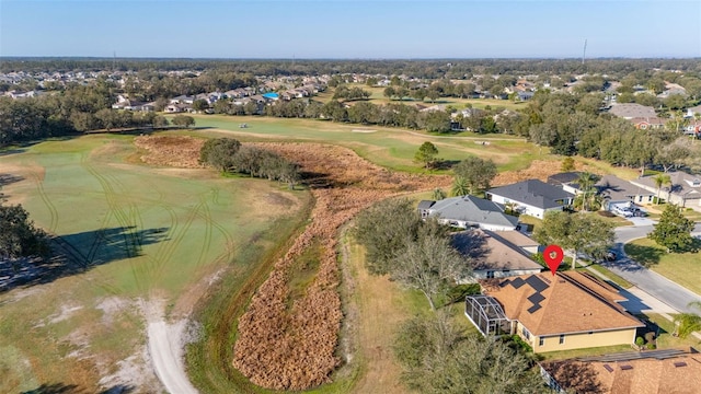 bird's eye view with view of golf course and a residential view