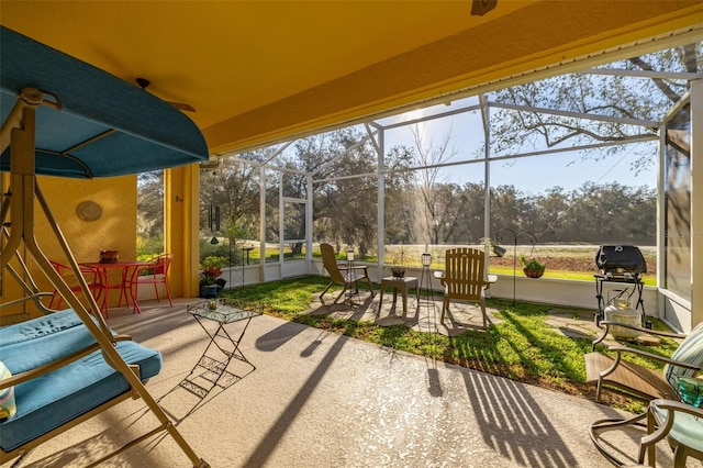 view of patio with outdoor dining area, a lanai, and grilling area