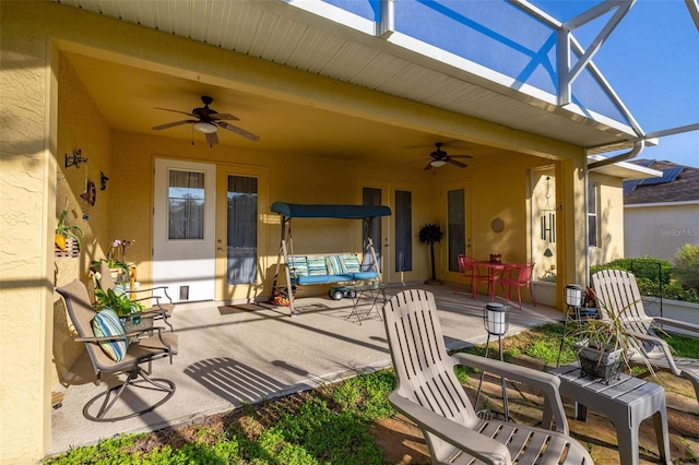 view of patio / terrace featuring ceiling fan and a lanai