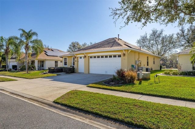 ranch-style house with an attached garage, driveway, stucco siding, roof mounted solar panels, and a front yard