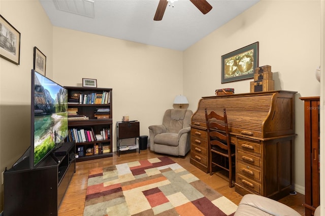 office space with visible vents, ceiling fan, and wood finished floors