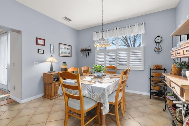 dining space featuring light tile patterned floors, a wealth of natural light, visible vents, and baseboards