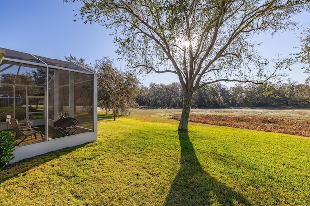 view of yard featuring glass enclosure