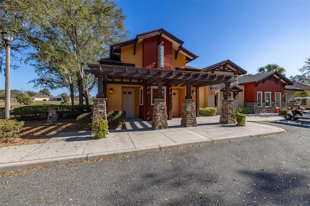 view of front of property featuring a pergola and stucco siding