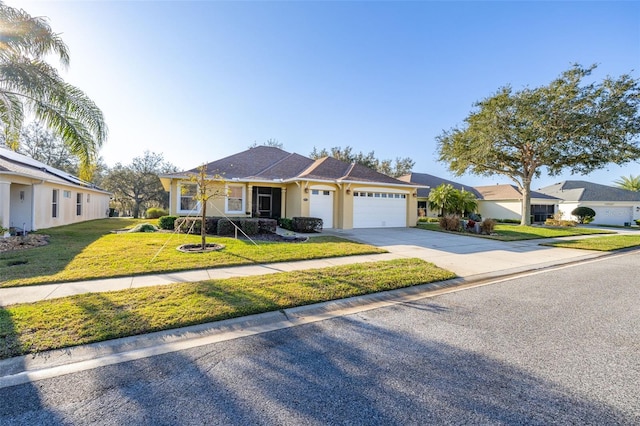 single story home with a garage, concrete driveway, a front yard, and stucco siding