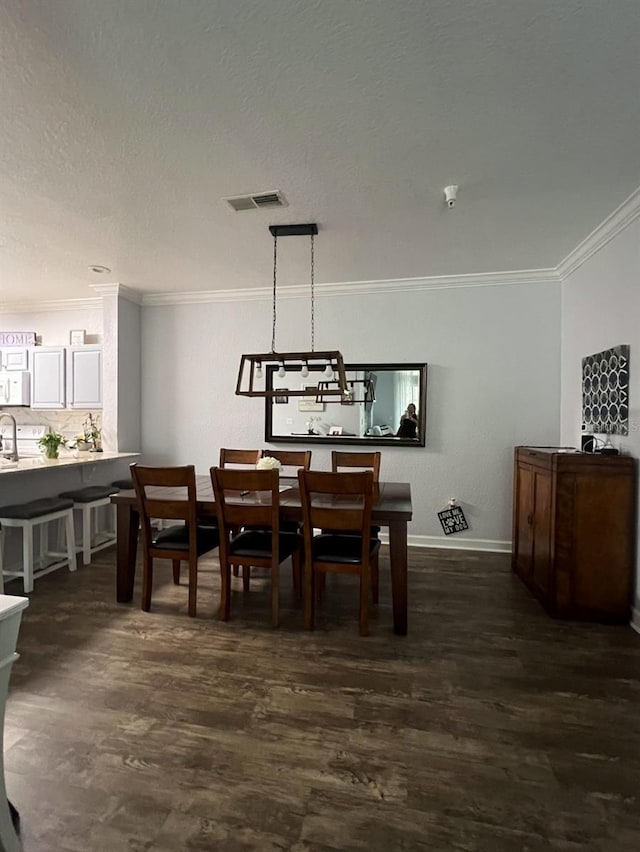 dining area with ornamental molding and dark wood-type flooring