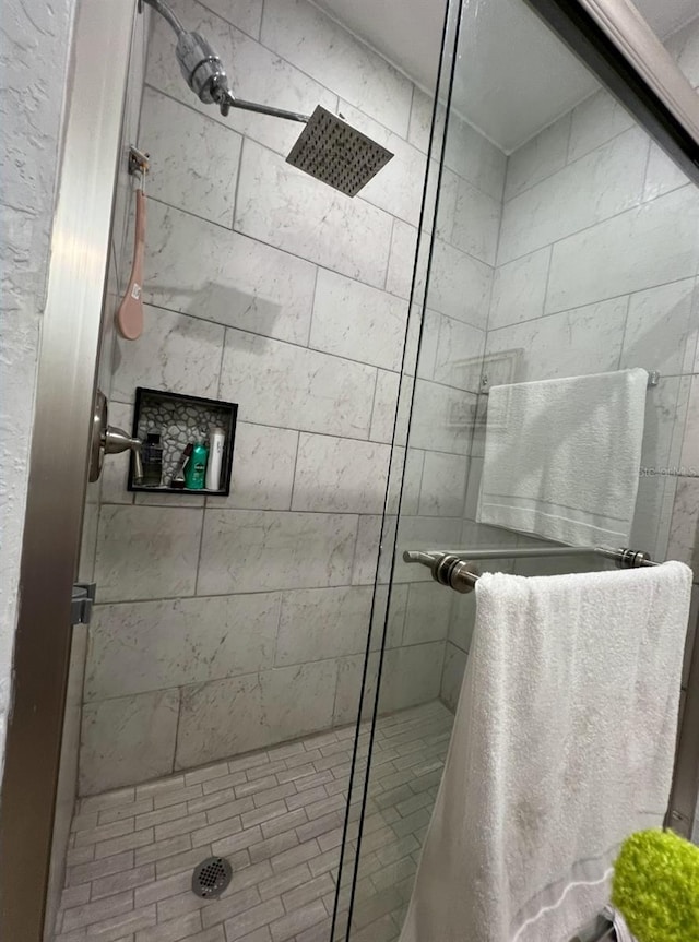 bathroom featuring a shower with shower door