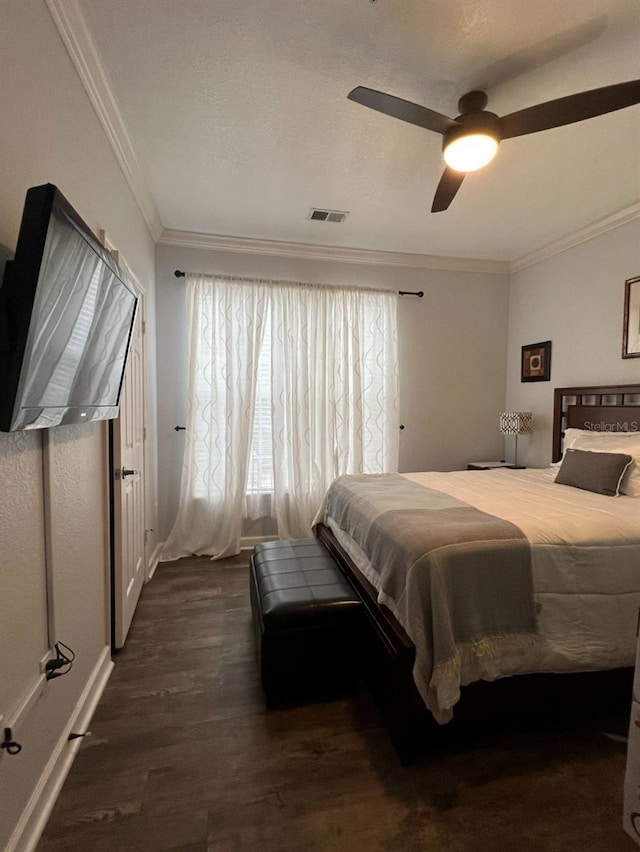 bedroom with multiple windows, dark hardwood / wood-style floors, ceiling fan, and crown molding