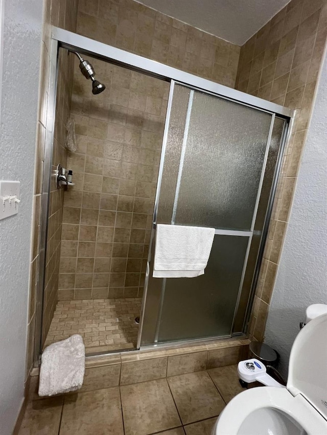 bathroom featuring toilet and an enclosed shower