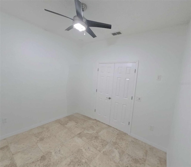 spare room with ceiling fan