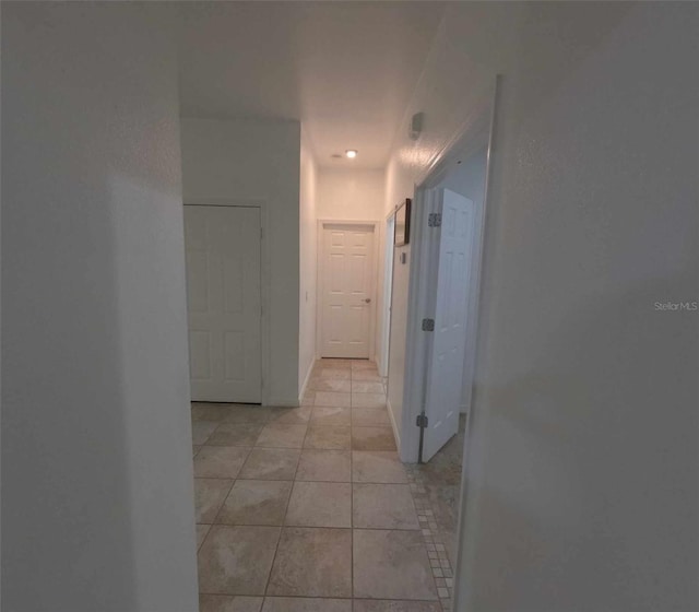 hallway featuring light tile patterned flooring