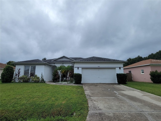 single story home featuring a garage and a front lawn