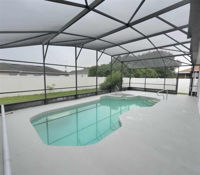 view of swimming pool with an in ground hot tub, a patio, and a lanai