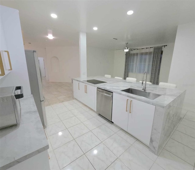 kitchen featuring white cabinets, white refrigerator, sink, stainless steel dishwasher, and ceiling fan