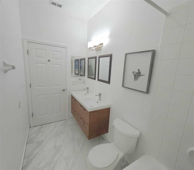 bathroom with vanity and toilet