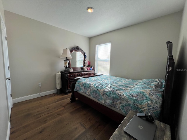 bedroom with dark hardwood / wood-style floors